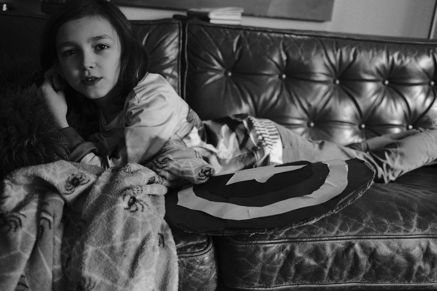 Thoughtful boy with homemade Captain America shield.