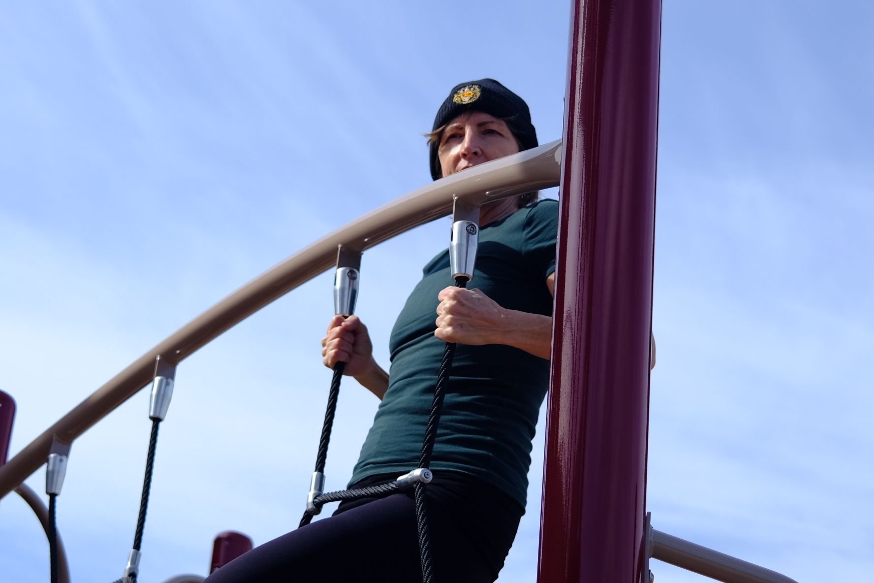 My mom climbing at the local playground.